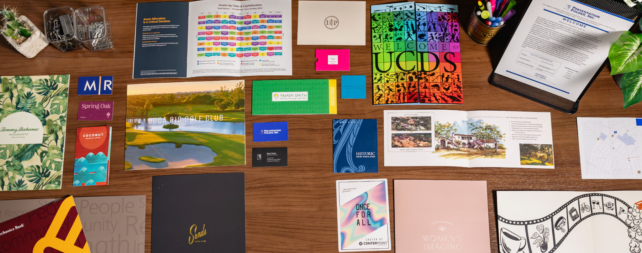 Assorted printed presentation and sales materials on a tabletop